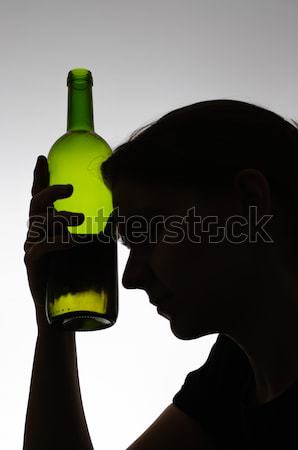 Alcoholic woman kissing a wine bottle Stock photo © CsDeli