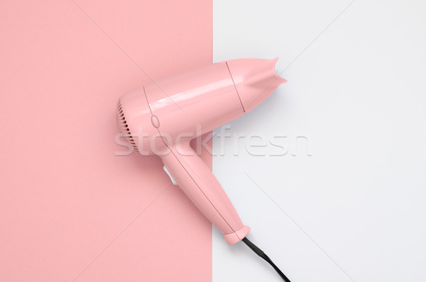 Pink hair dryer on pink and white background Stock photo © CsDeli