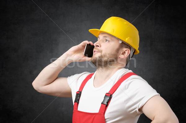 Construction worker using smartphone Stock photo © CsDeli