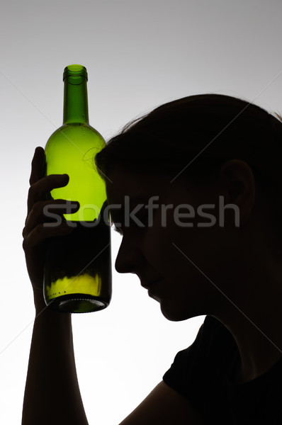 Silhouette of a woman holding a bottle Stock photo © CsDeli