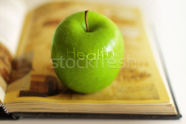Apple and book Stock photo © curaphotography