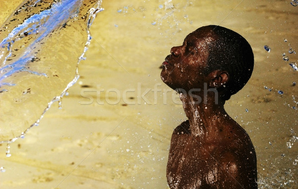 African băiat apă fotografie nisip negru Imagine de stoc © curaphotography