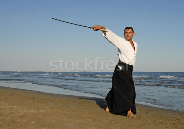 Aikido moço treinamento praia homem mar Foto stock © cynoclub
