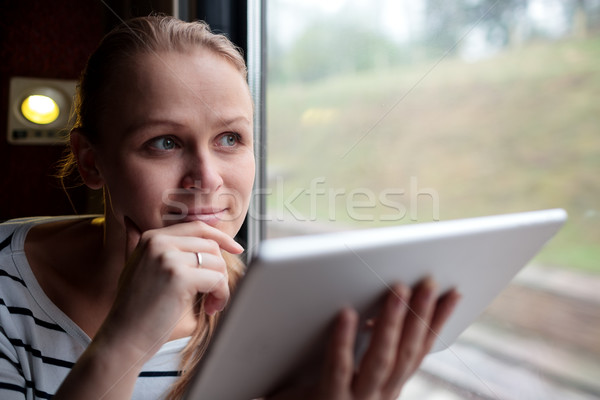 Smiling young woman traveling by train Stock photo © d13