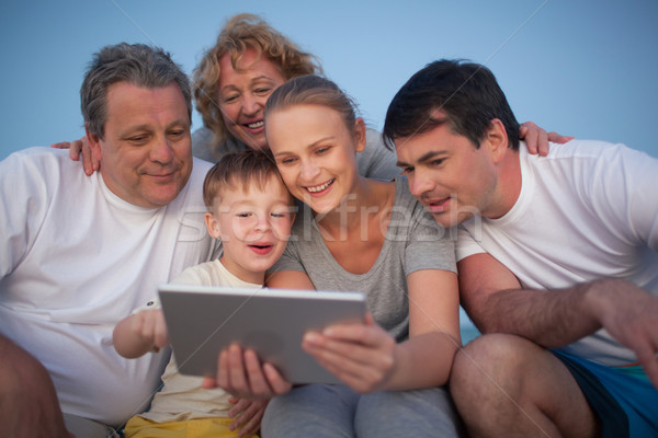 Happy family spending time with pad outdoor Stock photo © d13