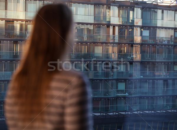 Woman looking at an apartment block Stock photo © d13