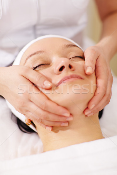 Woman in the beauty spa getting a facial massage Stock photo © d13