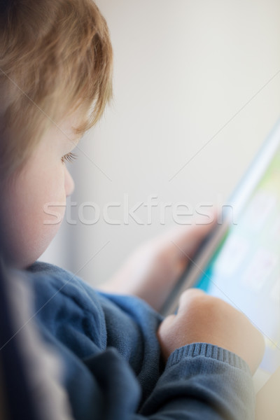 Stock photo: Young boy using smart tablet