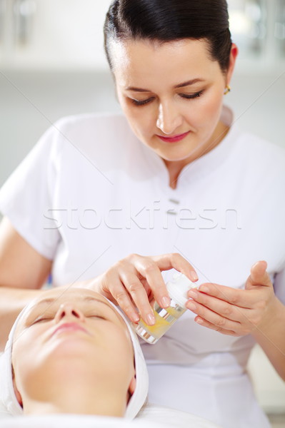 Cosmetician is going to apply facial cosmetic Stock photo © d13