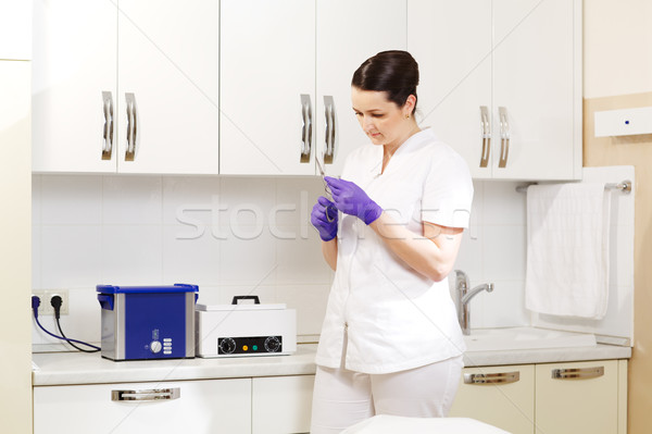 Cosmetician preapring tools for sterilization Stock photo © d13