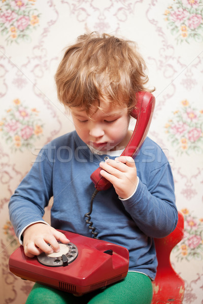 Small boy talking on a red telephone Stock photo © d13