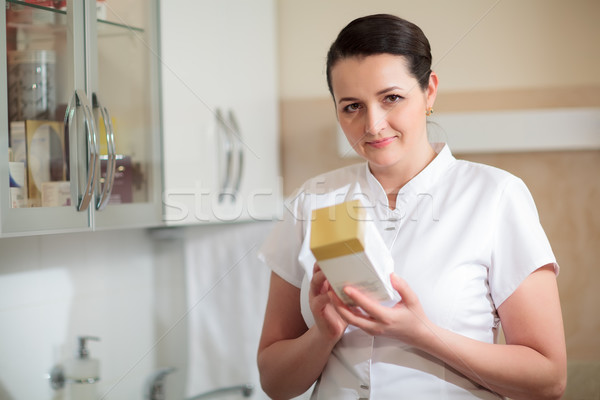 Cosmetician holding box with cosmetic Stock photo © d13
