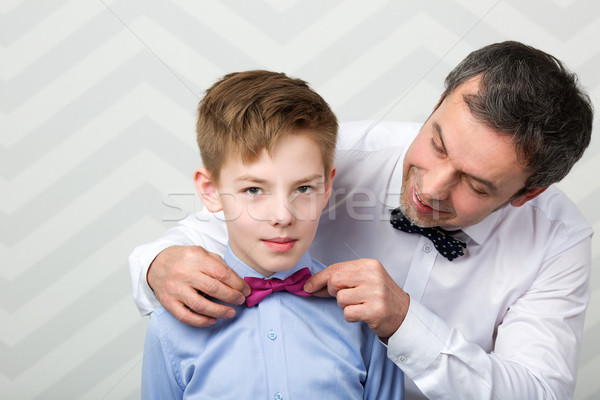 Father adjusting sons bowtie Stock photo © d13