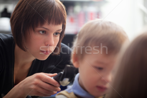 Hairstylist cutting a young boys hair Stock photo © d13