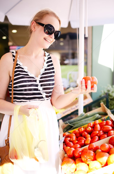 Young woman shopping for fresh tomatoes Stock photo © d13