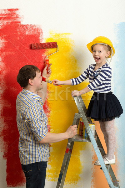 Family fun during wall painting Stock photo © d13