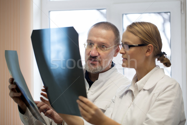 Professor and young doctor comparing x-rays Stock photo © d13