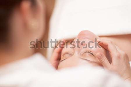 Woman getting professional facial massage Stock photo © d13