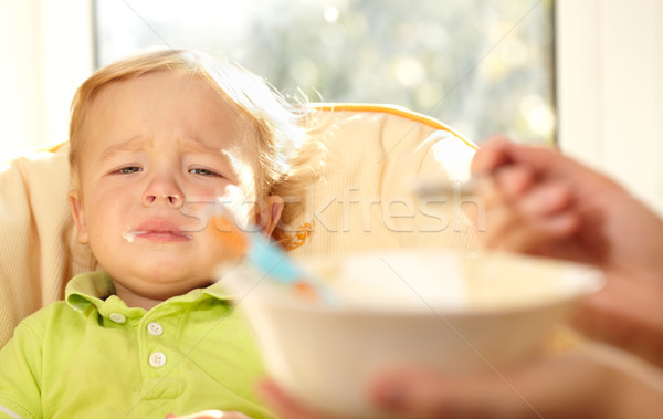 Kid is very disappointmented about porridge. Stock photo © d13