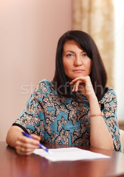Attractive middle-aged woman working at home Stock photo © d13