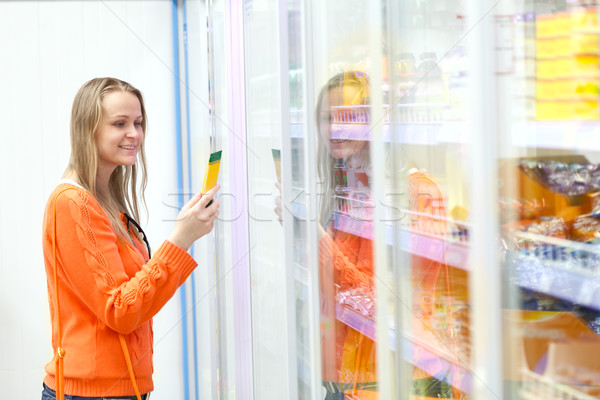 Woman taking product from the showcase Stock photo © d13