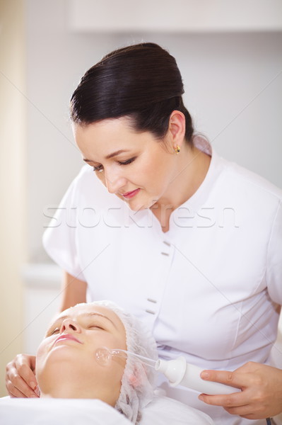 Woman under facial spa procedure Stock photo © d13
