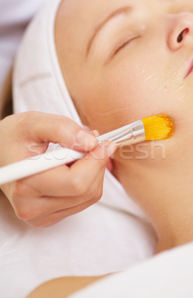 Woman being applied a facial mask Stock photo © d13