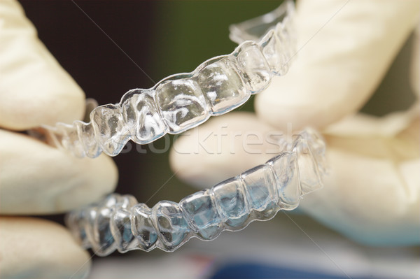 Doctors hands holding silicone mouth guard Stock photo © d13