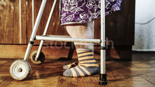 Elderly woman going slowly with the help of walker Stock photo © d13
