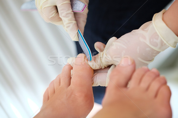 Woman feet during filing Stock photo © d13