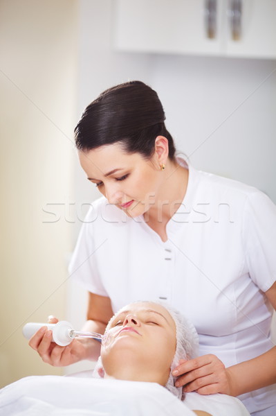 Woman under anti-aging therapy at beauty treatment salon Stock photo © d13