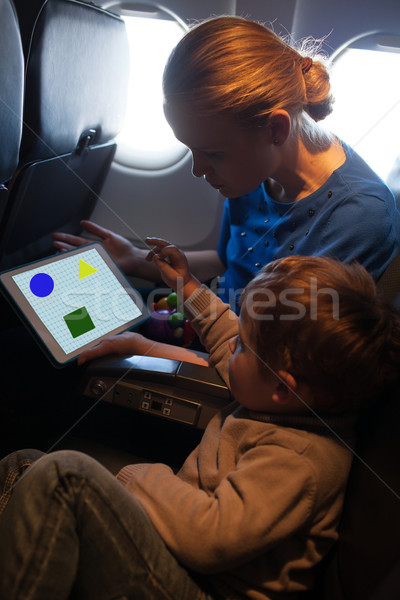 Young mother and son traveling on an aeroplane Stock photo © d13