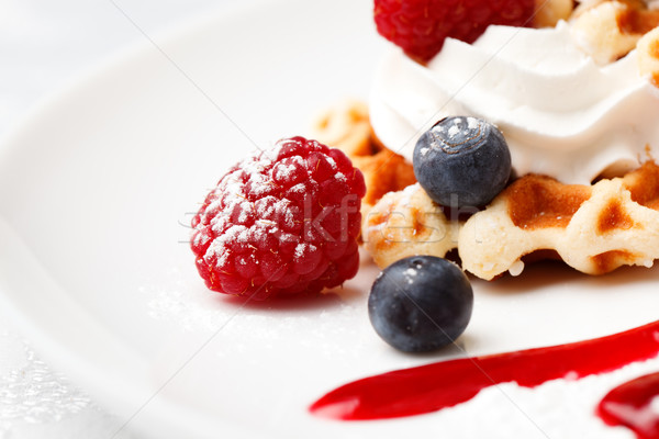 Golden waffle served with cream and berries Stock photo © d13