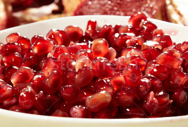 Pomegranate seeds in a white bowl. Stock photo © d13