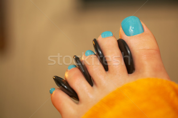 Spa feet treatment with massage stones Stock photo © d13