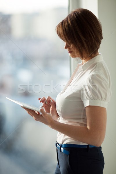 Side view of adult woman using tablet  Stock photo © d13