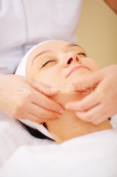 Massage of face at beauty treatment salon Stock photo © d13