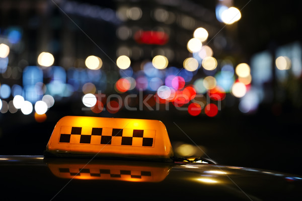 Illuminated taxi cab sign on a city street Stock photo © d13
