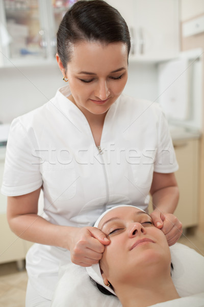 Woman under facial massage at beauty spa Stock photo © d13