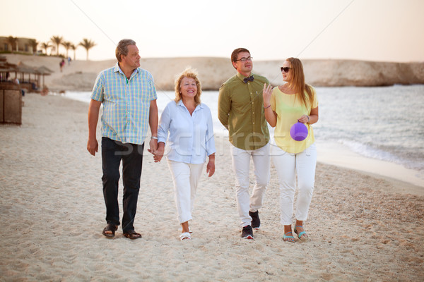 Young and senior couples walking along the coast Stock photo © d13