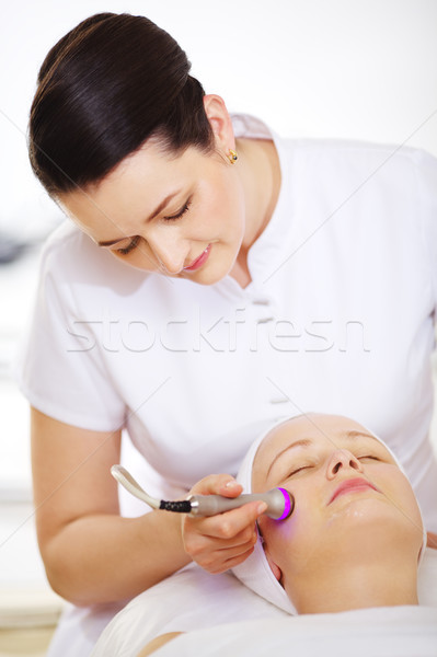 Cosmetician providing lifting procedure with special equipment Stock photo © d13