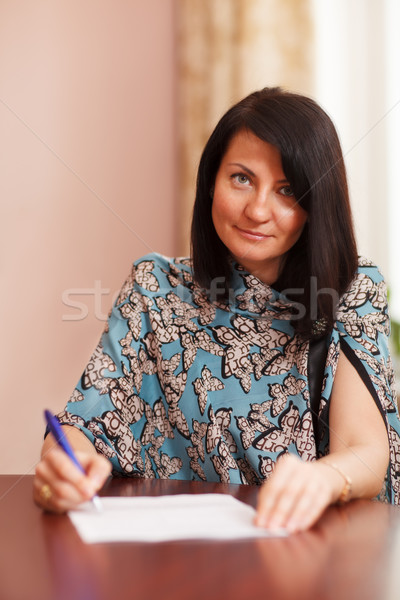 Attractive woman writing notes Stock photo © d13