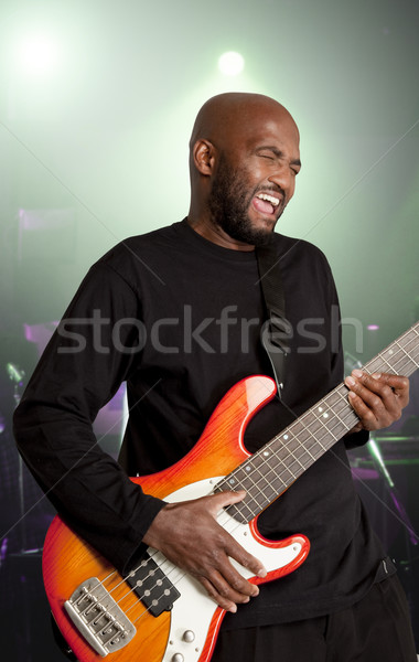 Stock photo: Bassist performing ons stage.