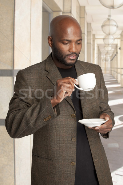 Man having coffee outside office building. Stock photo © danienel