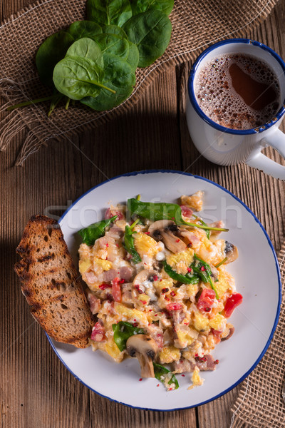 Scrambled eggs with tomatoes and spinach Stock photo © Dar1930