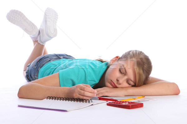 Tired school girl falls asleep doing math homework Stock photo © darrinhenry
