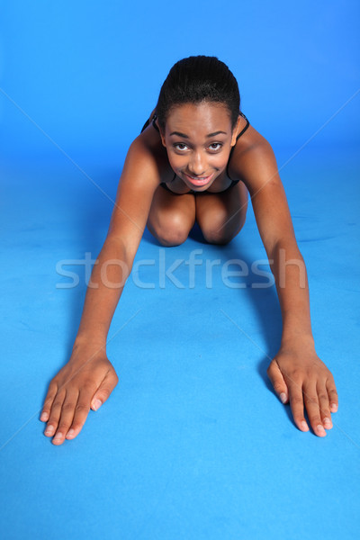 Warm up back stretch exercise by African woman Stock photo © darrinhenry