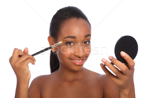 African american woman using eye shadow brush Stock photo © darrinhenry