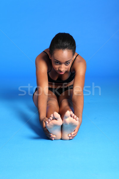Beautiful African fit woman hamstring stretch Stock photo © darrinhenry