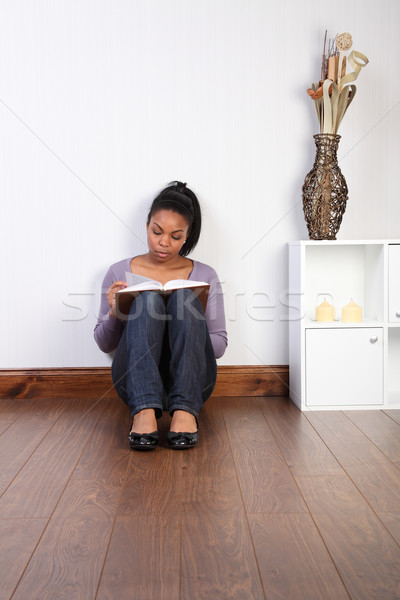 Lazy day at home reading a book on the floor Stock photo © darrinhenry